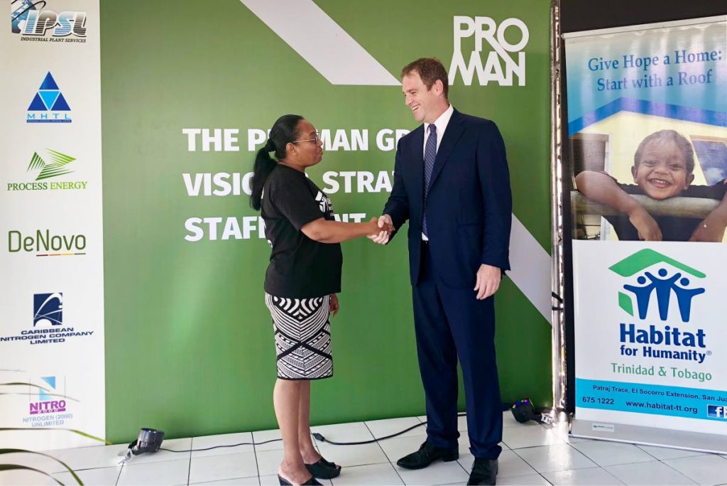 Proman chief executive David Cassidy and Habitat Trinidad national manager Jennifer Massiah seal the partnership with a handshake.