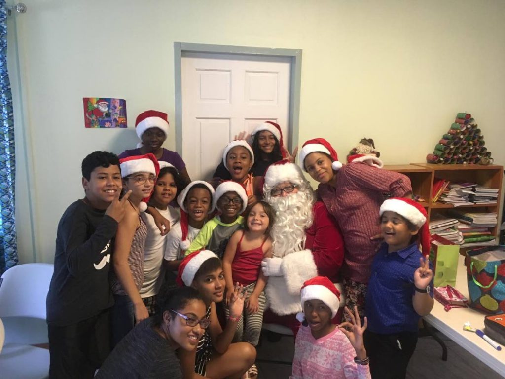 Ricardo Allen as Santa Claus surrounded by happy kids from a local children’s home earlier this month.