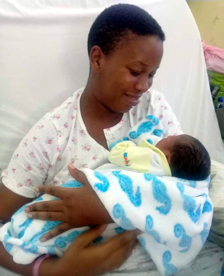 HAPPY BUT UNCERTAIN: Nisa Harry holds her son Messiah at the San Fernando General 
Hospital yesterday.