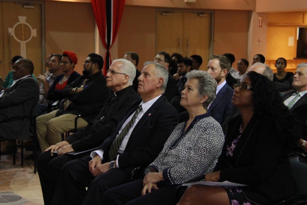 RAPT AUDIENCE: Attendees at a ribbon cutting ceremony to commemorate the 70th anniversary of the Universal Declaration of Human Rights held at St Finbar's RC Church, Diego Martin. From left are vicar for the northern vicariate Fr Christopher Lumsden, US Ambassador to TT Joseph Mondello and representatives of Living Water Community Rhonda Maingot and Rochelle Nakhid. 