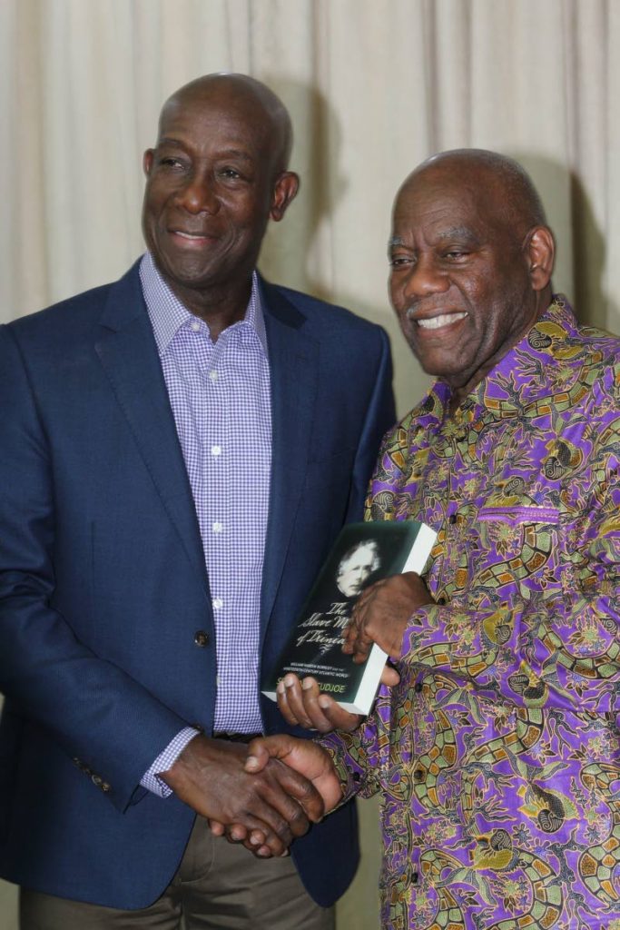 Prime Minister Dr Keith Rowley and Professor Selwyn Cudjoe, right, at the launch of Cudjoe’s book, The Slave Master, at the Central Bank auditorium, Port of Spain on December 13.