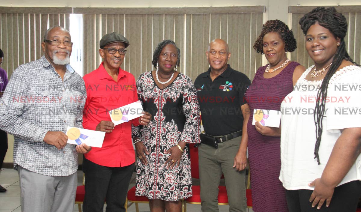 Pan Trinbago president Beverly Ramsey-Moore, centre, and NCC CEO Colin Lucas, third from right, alongside steelband representatives, from left, Hollister Smith of Pan Elders (medium), Michael Marcano of BP Renegades (large), Franka Hills-Headley and Vanessa Headley of Golden Hands (small) at the prize giving ceremony for 2018 Panorama finals winners at the VIP Lounge, Grand Stand, Queen's Park Savannah, Port of Spain yesterday. PHOTO BY ROGER JACOB.