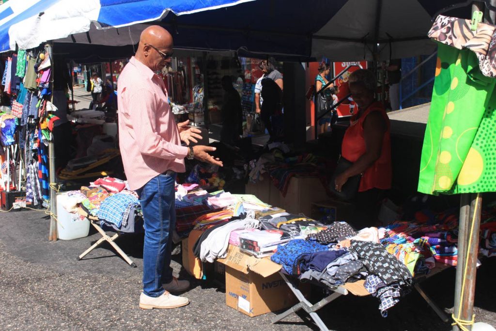San Fernando Mayor Junia Regrello chats with a High Street vendor before he makes a purchase. 