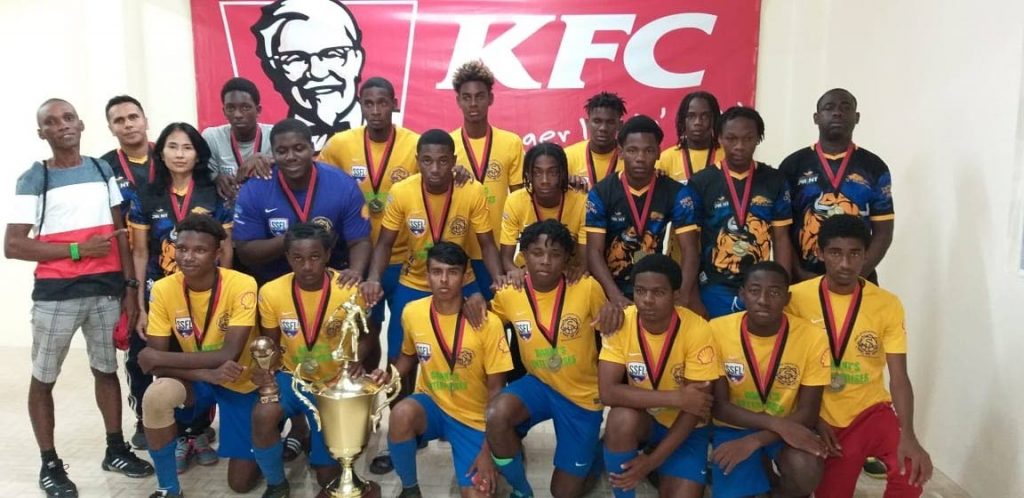 Shiva Boys footballers and technical staff celebrate after winning the KFC Goodwill Tournament in Guyana over the weekend. 