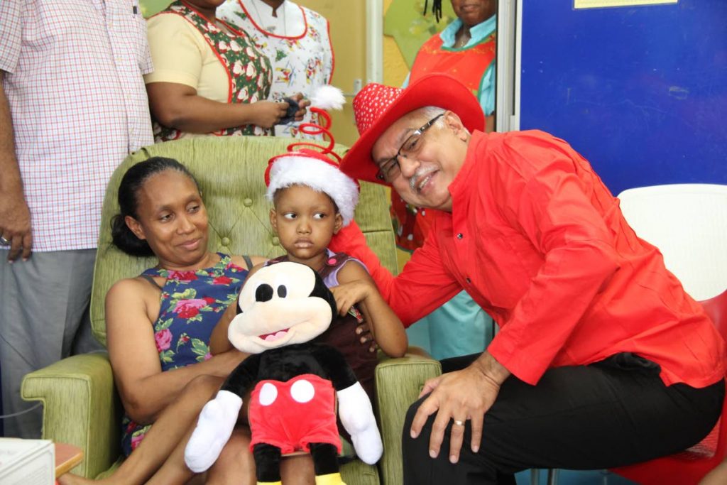 Health Minister Terrence Deyalsingh interacts with Dejana Barrington and her mother Jenny Plaza Barrington during a visit to the Wendy Fitzwilliam Paediatric Hospital, Mt Hope. PHOTO BY SUREASH CHOLAI