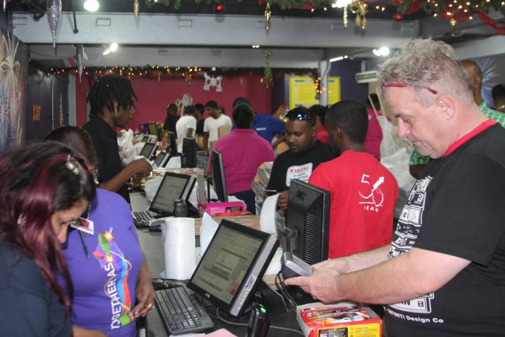 Hot seller: Customers buy fireworks at FireOne's Boxing Day sale in Macoya yesterday. PHOTOS BY ENRIQUE ASSOON