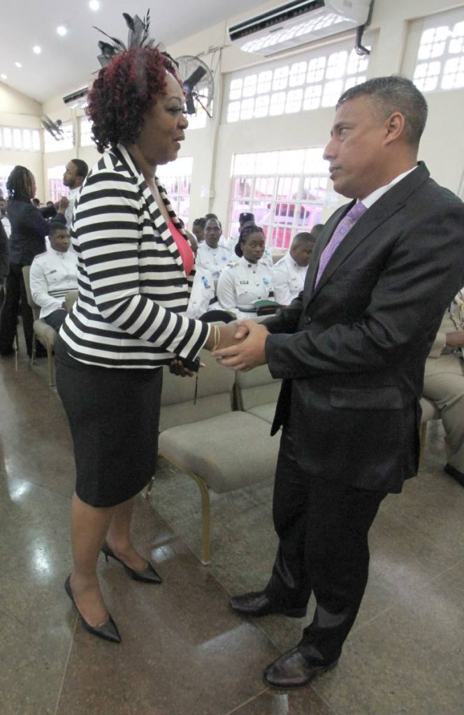 EXTENDING CONDOLENCES: Police Commissioner Gary Griffith greets Anne Marie Rogers, at the her son’s funeral service yesterday.