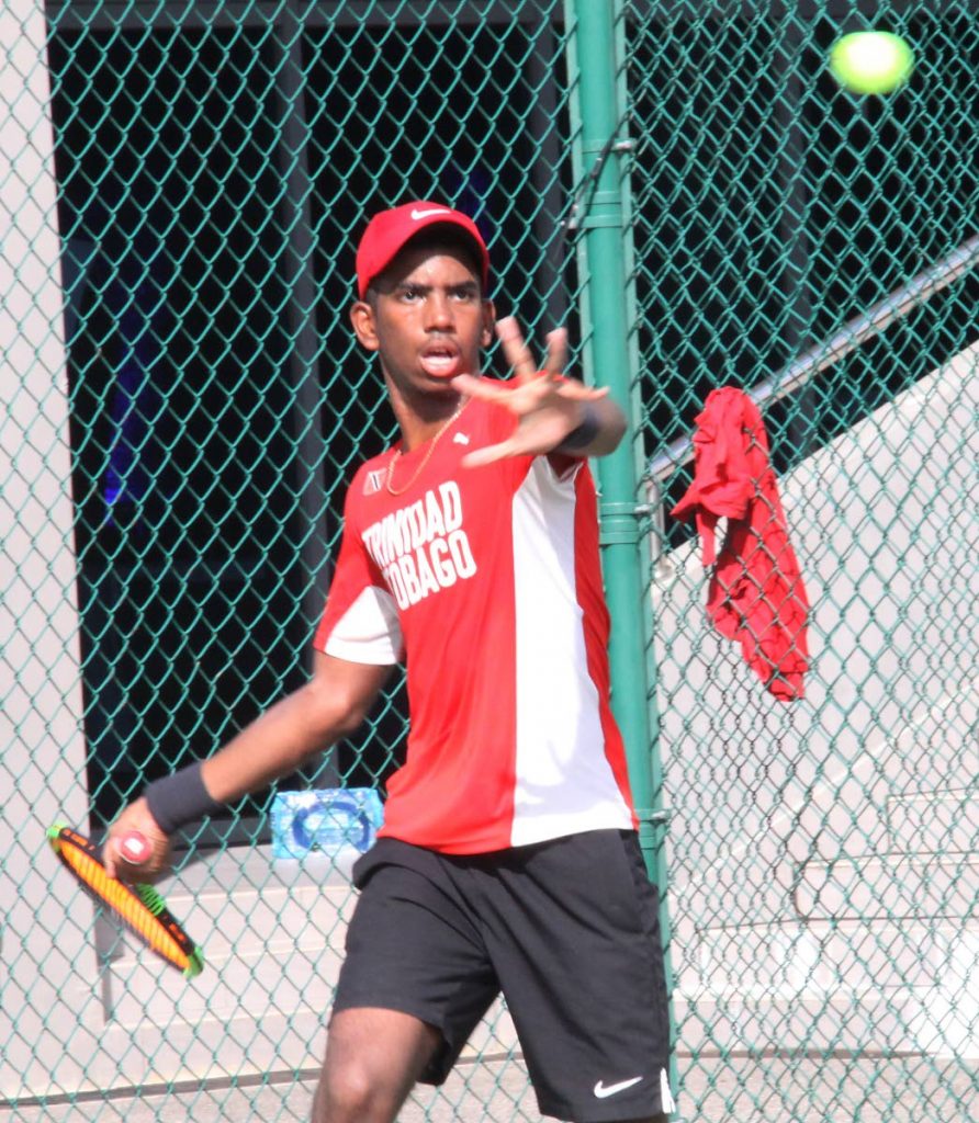 Aidan Carter in action at the Junior Davis Cup trials held yesterday, at the National Racquet Centre,Tacarigua.