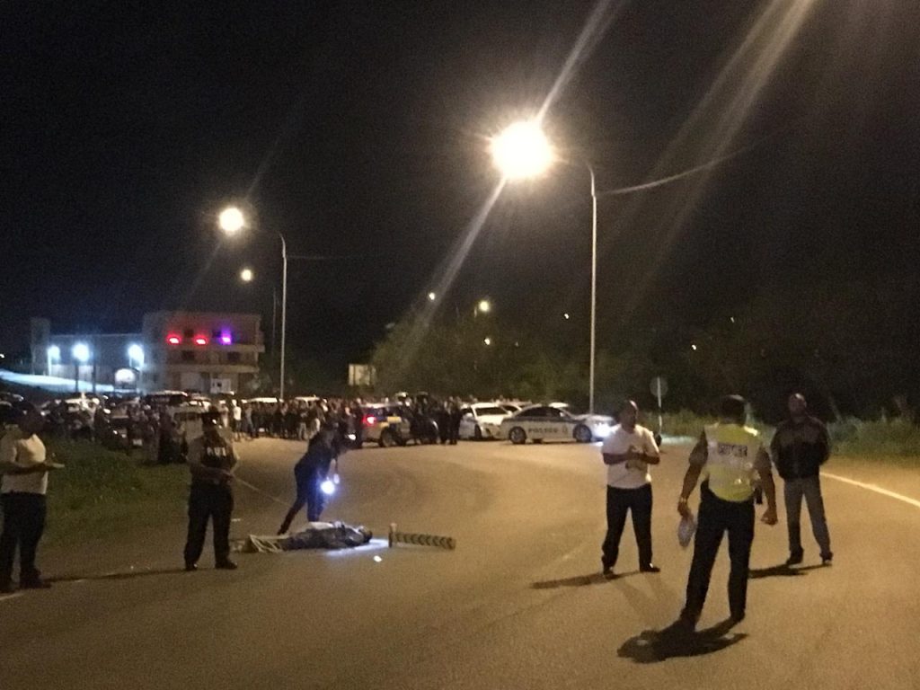 Police wait for a district medical officer to arrive to examine the body of Rondel Jaggesar who died after a car ran into his motorbike on SS Erin Road, Debe. PHOTO BY ANSEL JEBODH