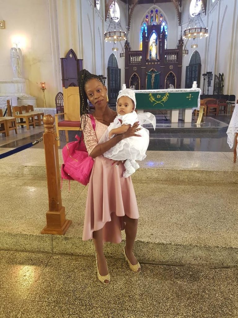 Akeila Schelborn, holds her 10 month old daughter Angel Smith in a church service earlier this year. 