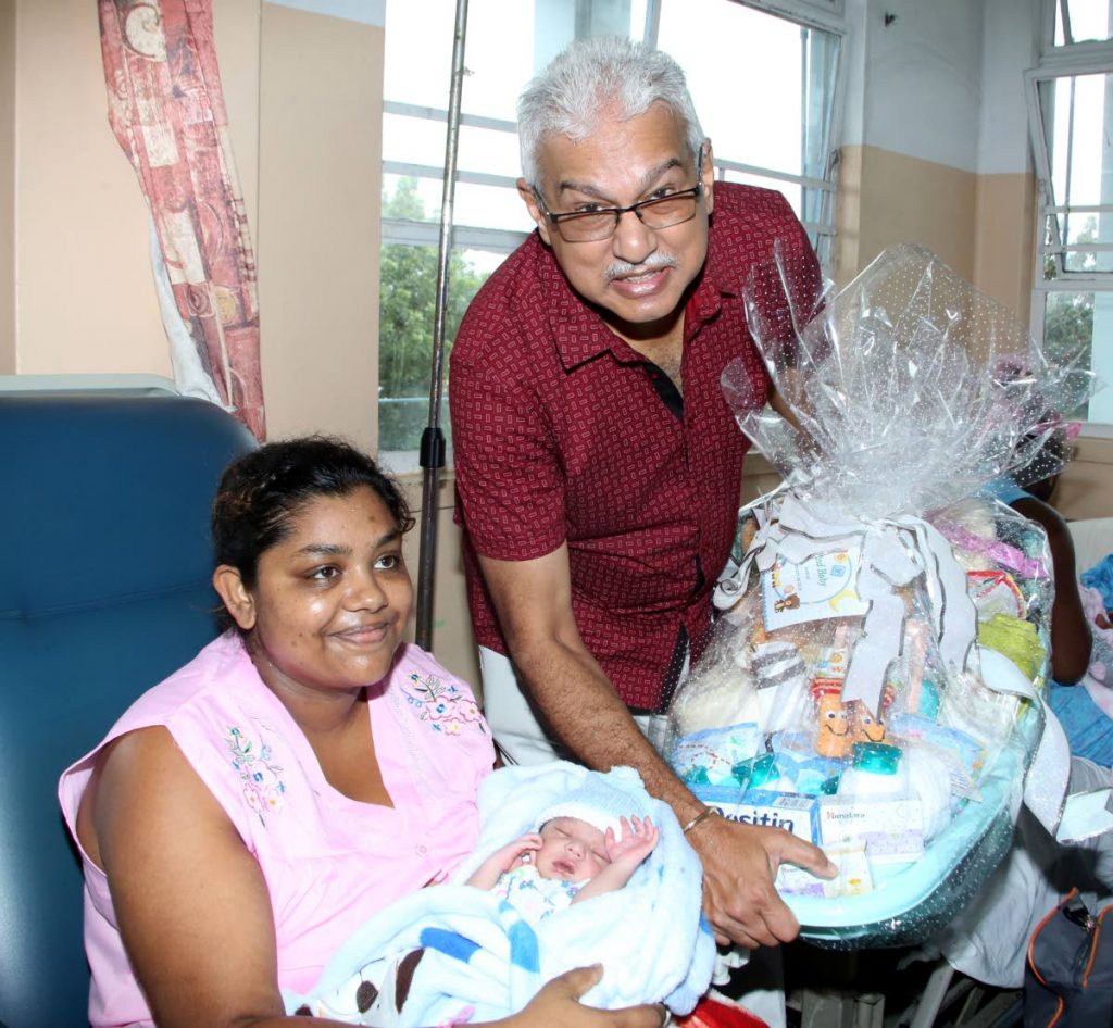 Minister of Health Terrence Deyalsingh right presented  a bathtub  full of goddies to the mother  Sharda Persad and  newborn baby boy  Kabiir,  at San Fernando General Hospital  on News years Day.  photo by Vashti Singh