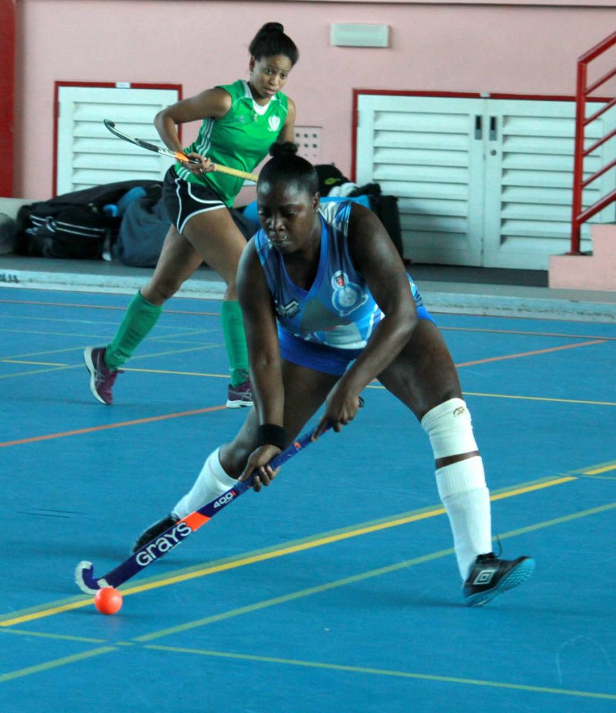 Police's Krystal Raymond shoots at goal against Ventures in the Ventures Indoor Hockey Tournament at UWI-SPEC, St Augustine, Saturday. 