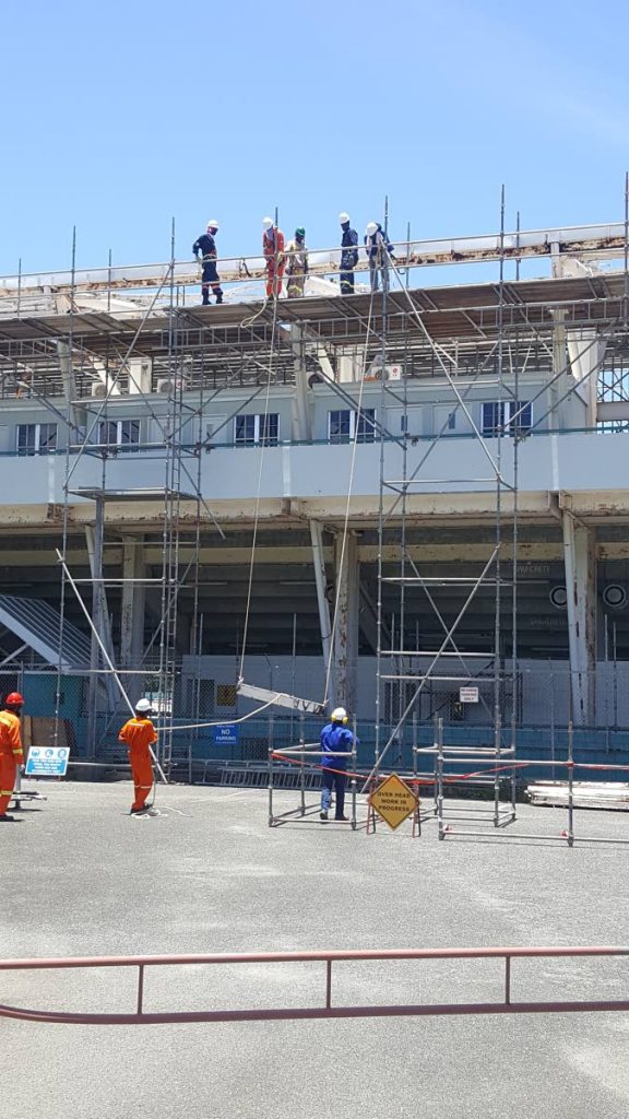 Workers work on removing the roof of the Dwight Yorke Stadium in Bacolet in August 2018 during a first phase of renovation works.