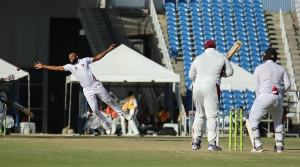 Leewards Islands batsman Rahkeem Cornwall plays a shot down the ground past Red Force spinner Yannic Cariah on day three of their four-day match at the Brian Lara Academy, Tarouba, Sunday. Photo by Vashti Singh