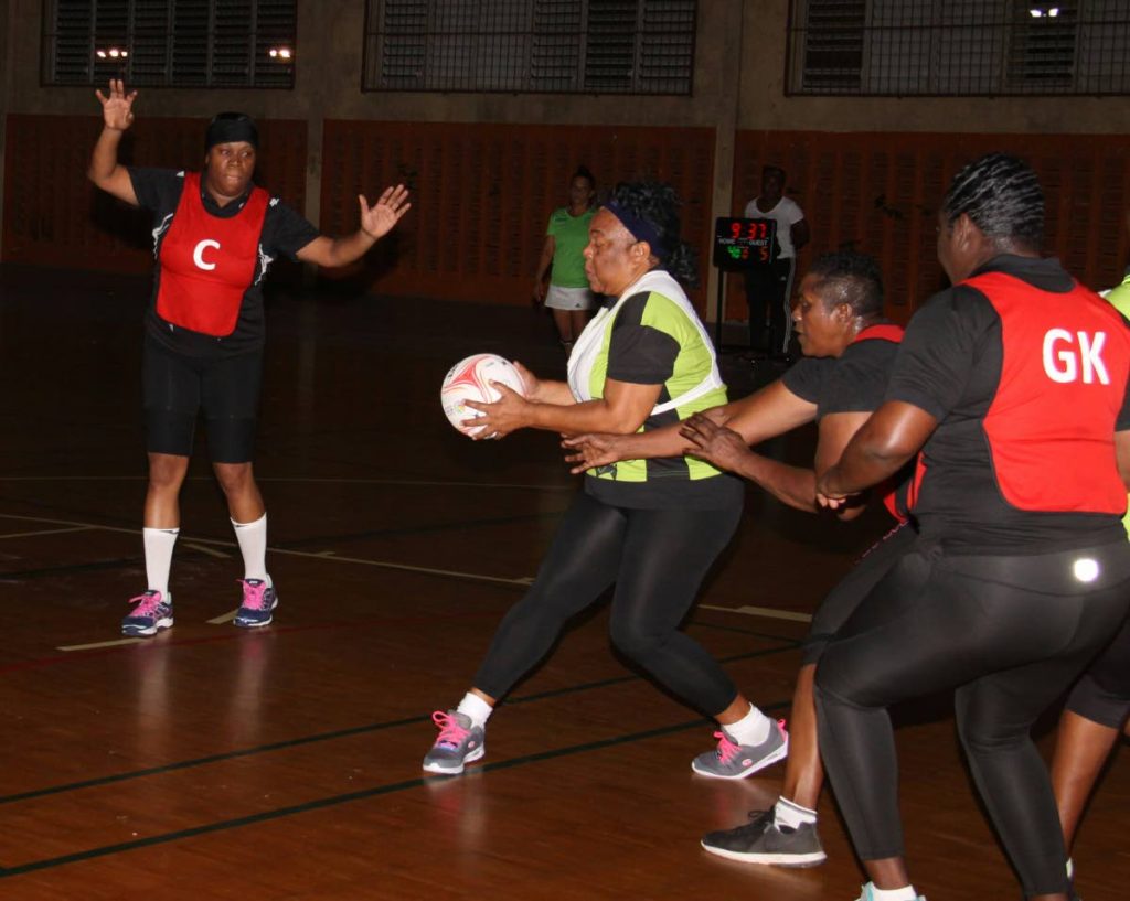 A TSTT player looks to make a pass against Police in a Courts All Sectors Netball League Retro Division match at the Eastern Regional Indoor Sports Arena, Tacarigua, Monday. PHOTO BY ANGELO MARCELLE 
