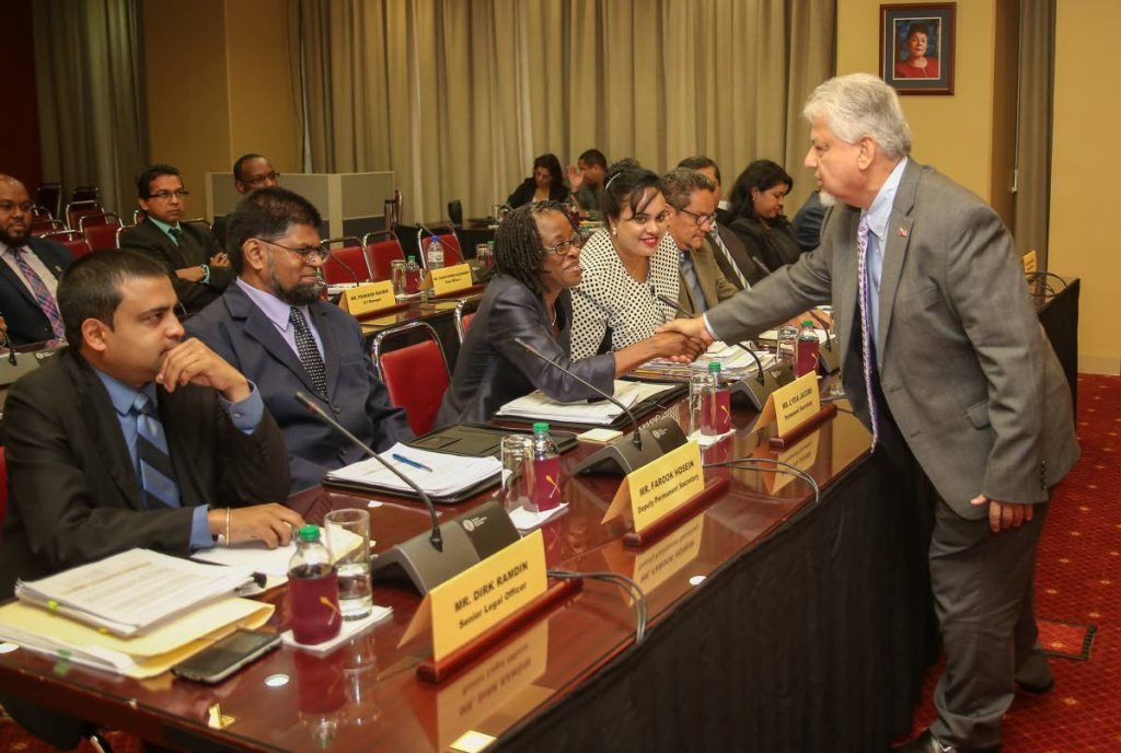 Chairman of Public Accounts Committee Dr Bhoendradatt Tewarie greets Agriculture Ministry Permanent Secretary Lydia Jacobs and officials of Namdevco yesterday at a meeting held at the Parliament building, Port of Spain. 