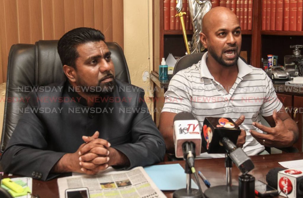Attorney Gerald Ramdeen, left, looks on as former Red Force assistant coach Imran Jan defends himself against accusations that he colluded with the TT Cricket Board president while as a director with the Sport Company.  The press conference was held yesterday at the Law Chambers of Gerald Ramdeen, Woodbrook. PHOTO BY JEFF MAYERS