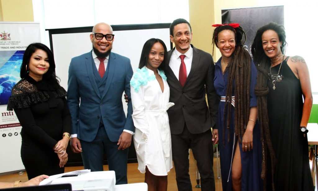 FashionTT GM Lisa Marie Daniel, designers Ecliff Elie and Jin Forde, FashionTT Chairman Jason Lindsay and twin designers Asha and Ayanna Diaz pose for a photograph at the Fashion TT press conference. 