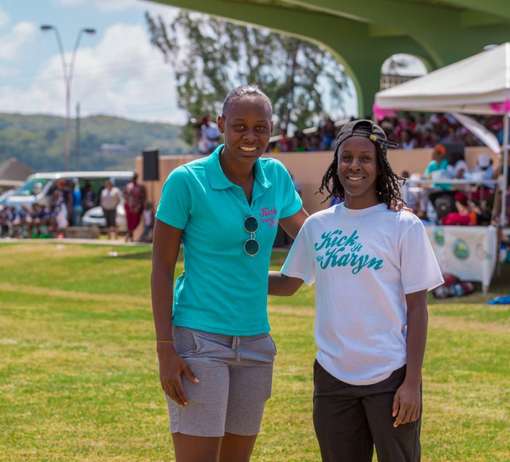 Karyn Forbes, left, midfielder with the TT National Women’s Football team, and national player Kennya Cordner, who also plays professional football with IL Sandviken Women’s Football team in Norway, pose for a photo at the 5th annual ‘Kick it with Karyn’ one-day tournament at the Plymouth recreation grounds on January 5.