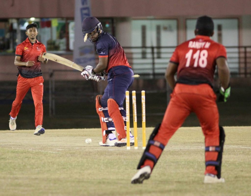 BOWLED: Combined Campuses and College’s Leonardo Friginette looks back at his wicket as he is bowled by TSATT’s Amit Sankar (L), on Saturday night, during their UWI World Universities T20 match, at the Sir Frank Worrell Ground, St Augustine.