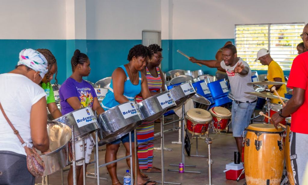 Arranger Michael Toby takes a handful of players through a practise session of Niala Blackman’s Iron Love at the Redemption Sound Setters Steel Orchestra pan threatre in Montgomery, Bethel, last Saturday.   Photos by David Reid