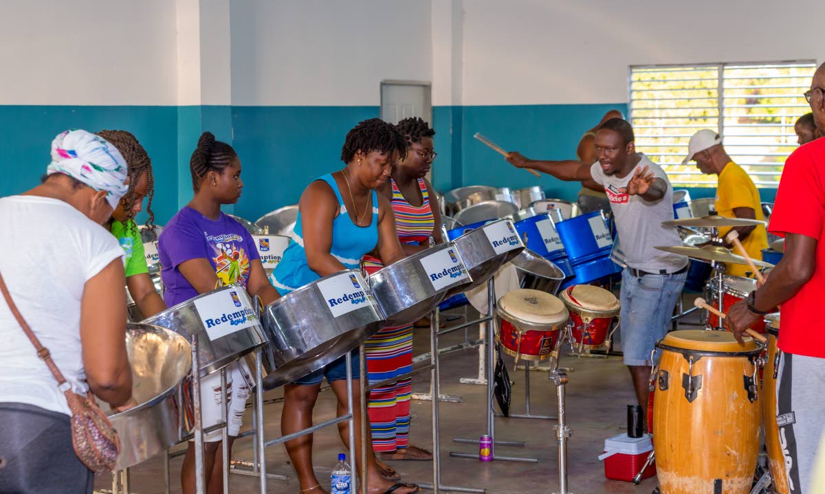 Arranger Michael Toby takes a handful of players through a practise session of Niala Blackman’s Iron Love at the Redemption Sound Setters Steel Orchestra pan threatre in Montgomery, Bethel, last Saturday. Photos by David Reid