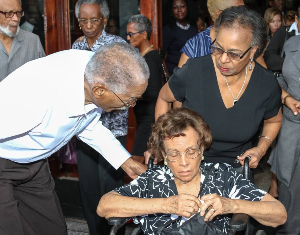 MY CONDOLENCES: Velda Masson, wife of former EBC chairman Dr Norbert Masson, is assisted by former senator Helen Drayton - a close family friend, at his funeral yesterday.  PHOTO BY JEFF K MAYERS