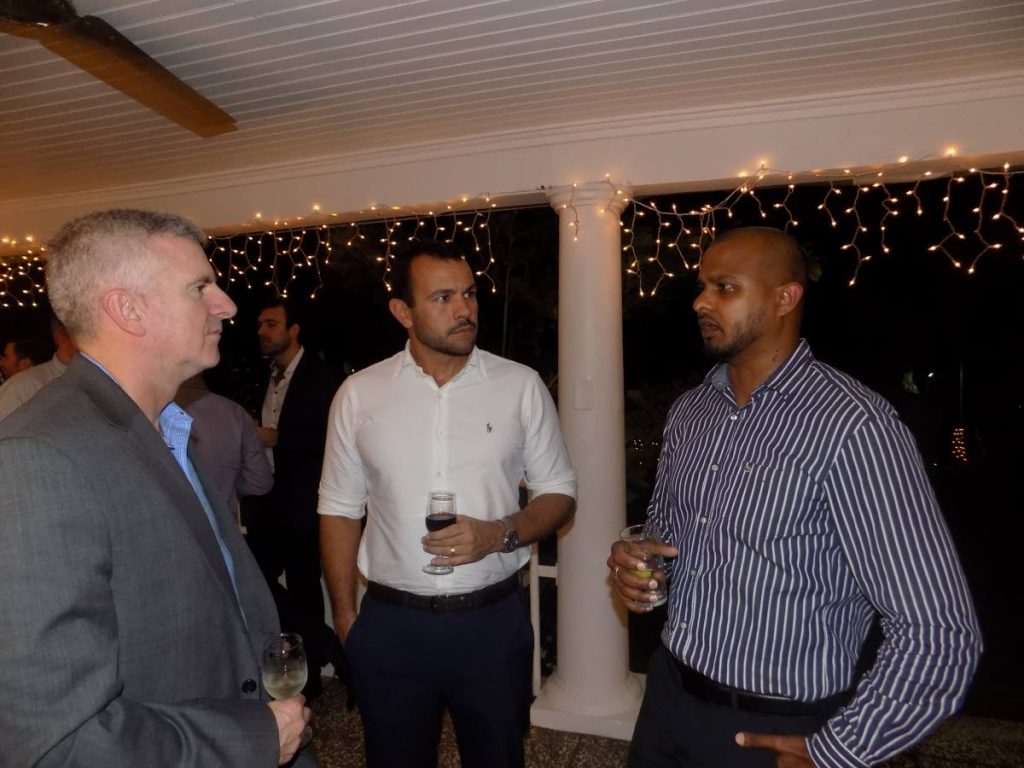 Business development manager at Massy Wood Vijay Jaggassar, right, speaks to RST Global managing director Eduardo Varela and VP of operations at Petrofac Kevin Mackie during a cocktail reception at the British High Commissioner's Maraval residence on Monday night. PHOTO BY SHANE SUPERVILLE