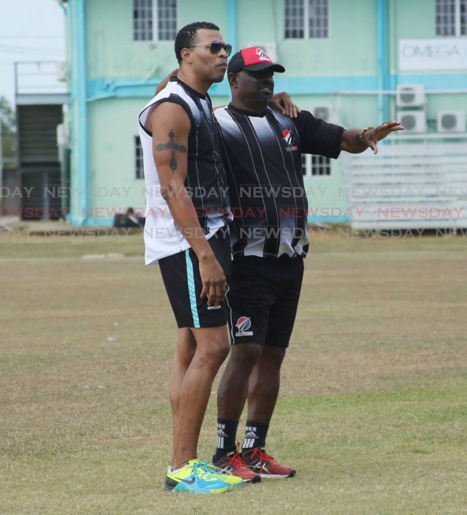 HELPING HAND: Former West Indies pacer and new Red Force assistant coach Mervyn Dillon, left, observes a training session alongside head coach Kelvin Williams, right, at the National Cricket Centre, Couva, yesterday. PHOTO BY VASHTI SINGH 