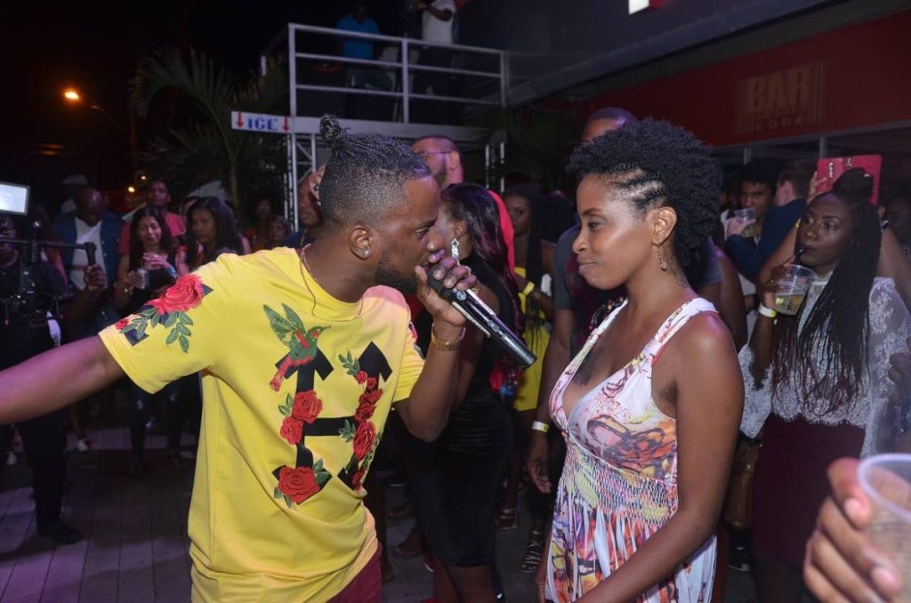 Reigning New Tobago Soca Monarch, Jhevon “Royale” Jackson sings to a patron at Barcode’s first event in the series, ‘I Love Soca,’ last week Tuesday at the Milford Road, Scarborough club. 