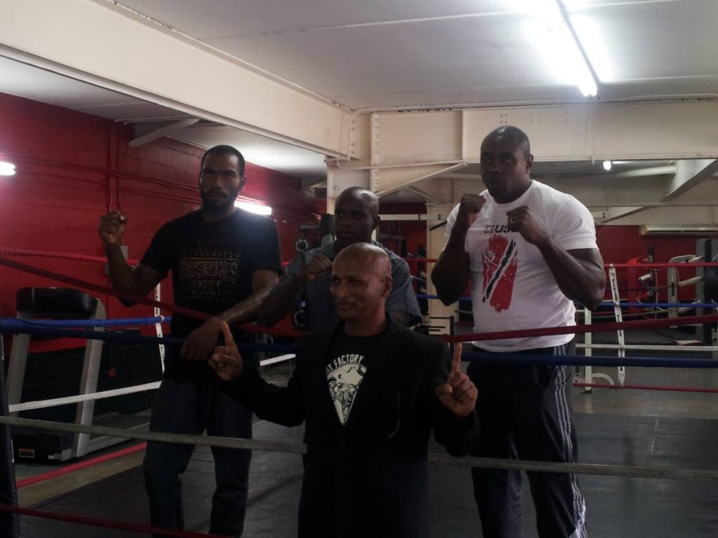 Boxing promoter Bharrath Ramoutar, front, with boxers Kevon Diaz, from left, Prince-Lee Isidore and Kennet Bishop.