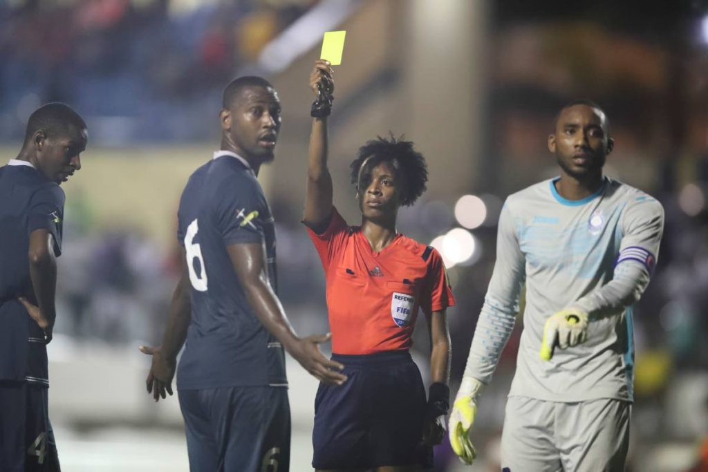 In this July 25,2017 file photo, match referee Crystal Sobers issues Police FC’s Jibri Mc David (#6) a yellow card and a penalty to North East Stars, during the TT Pro League match between North East Stars and Police FC, at the Arima Velodrome. North East Stars won 3-2.