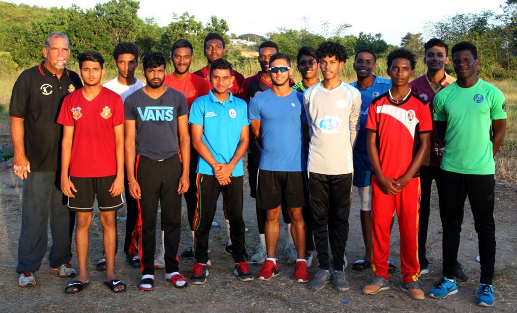 Coach Richard Kelly,back row left, and members of the Hillview College cricket team, at the team practise session, at Honeymoon Park, Tunapuna, yesterday.