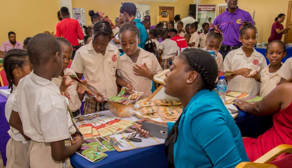 Students of the Mt St George Methodist Primary School learn about products made by the Tobago Cassava Products Ltd at the YES Community Career Expo at the
 Mt St George Community Centre last Thursday.