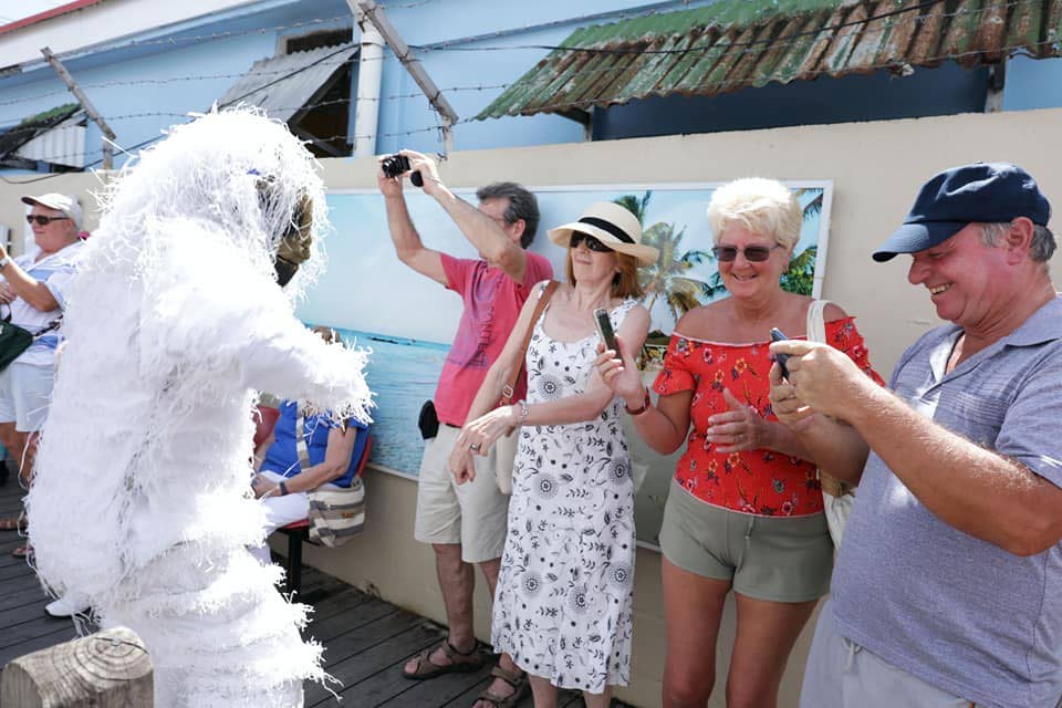 Tourists from the cruise ship, MV Ventura, meet up with a gorilla in the street procession for the launch of Tobago Carnival 2019 in Scarborough on Monday.