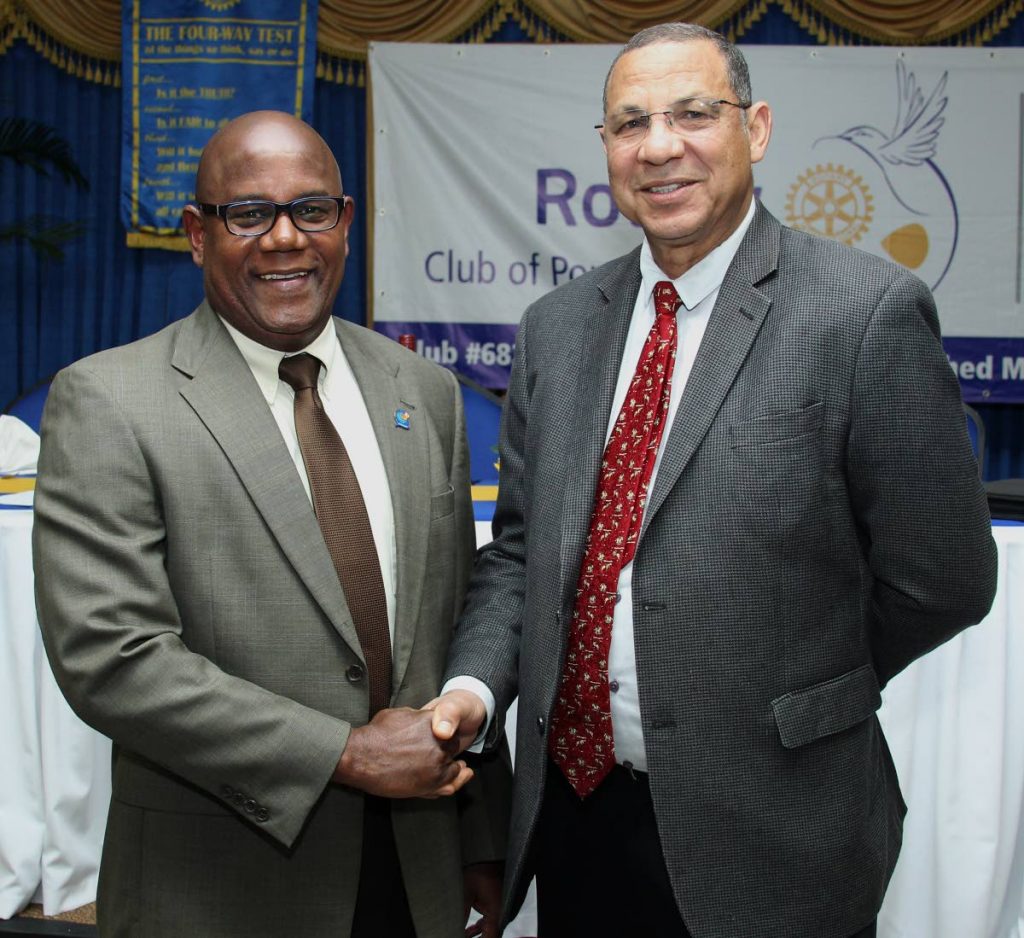 Economist Mariano Browne, former senator and minister, is congratulated by Hadyn Gittens, president of Port of Spain District of the Rotary Club of T&T  after Browne’s lecture on behalf of the club at Goodwill Industries, Woodbrook, on Tuesday.