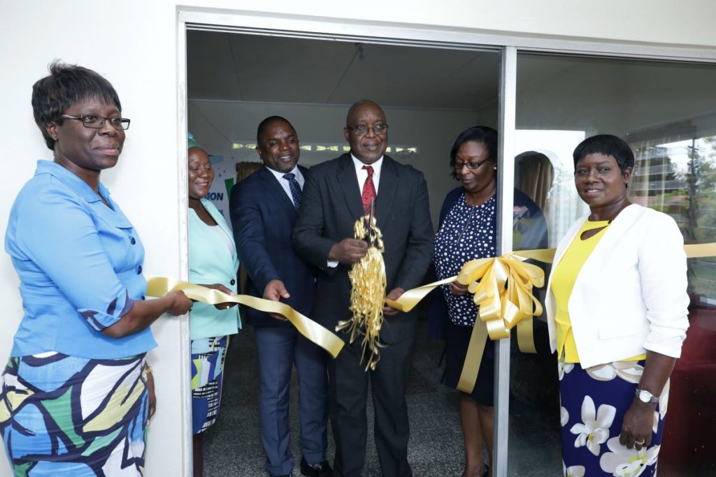 Chief Secretary and Secretary of Education Kelvin Charles, centre, curs the ribbon to open the Learning Enrichment Centre at Hope Farm Road, Hope, on Monday. Others in photo, from left, are Chairman of the Tobago PTA, Denise Nelson-Frank, School Supervisor III Sherry-Anne Rollocks-Hackett, Secretary of Finance Joel Jack, Administrator in Division Jacqueline Job and the Centre’s Manager, Suzette Woods-James.