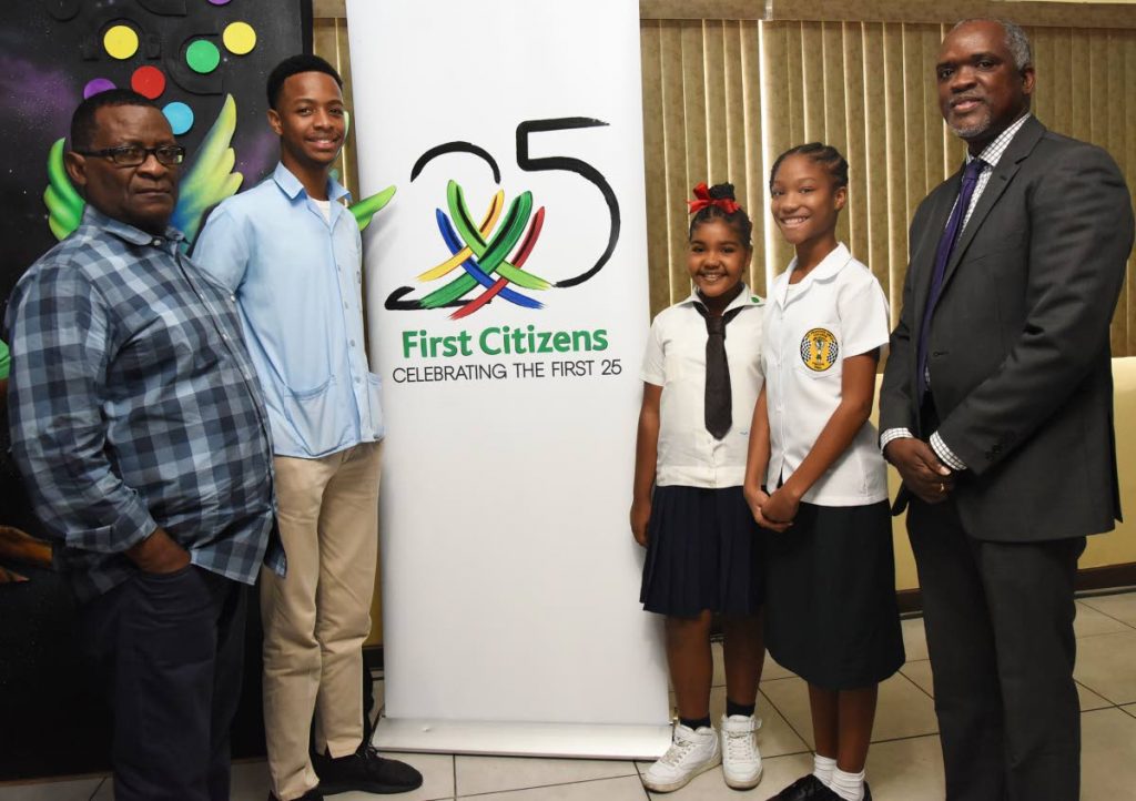 General secretary of TUCO  Wayne Mc Donald, left, and First Citizens chief information officer Wendell Mitchell, at right, with some of the Junior Calypso contestants during the launch of Junior Calypso 2019 at the VIP Lounge, Queen’s Park Savannah, Port of Spain on Wednesday.