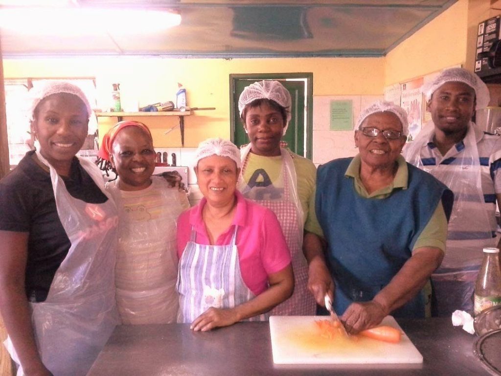 Entrepreneur Sylvia Dates-Lindsay, second from right, stands with some of her employees at Sylvia’s restaurant in Bon Accord.