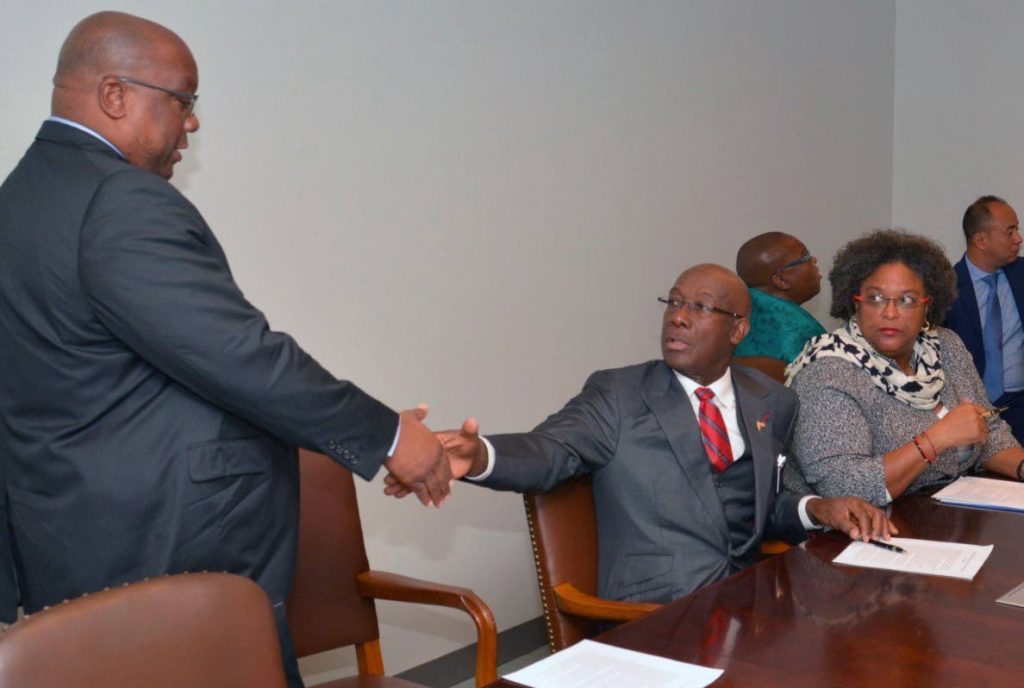 PEACE SHAKE: Prime Minister Dr Keith Rowley greets Caricom chairman and St Kitts and Nevis PM Dr Timothy Harris, left, yesterday as a Caricom delegation met with UN Secretary General Antonio Guterres to discuss the Venezuelan crisis. Sitting next to Rowley is Barbados PM, Mia Mottley. PHOTO COURTESY OPM