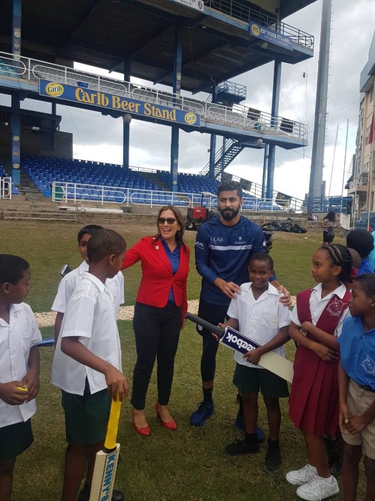 Primary School cricketers have fun with Trinbago Knight Riders pacer Ali Khan and Rotary Club president Jennifer Abraham at the Queen’s Park Oval, St Clair yesterday.