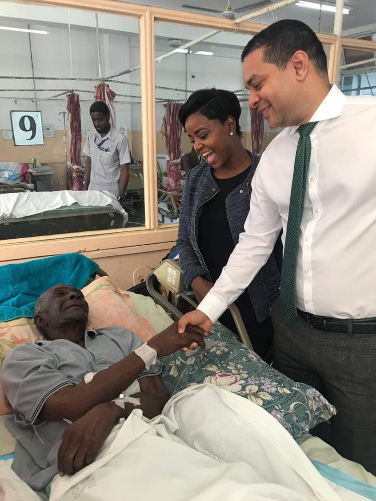 Cocoyea fire victim,  Evan Williams resting at the San Fernando General Hospital is visited by Cocoyea/Tarouba councillor Teresa Lynch and San Fernando East MP Randall Mitchell.