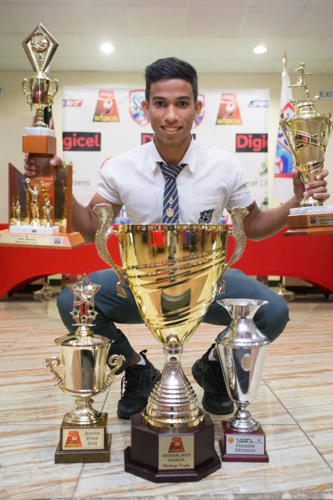 Naparima College footballer Mark Ramdeen poses with his trophies after being honoured at the Secondary Schools Football League awards, at the Couva/Pt Lisas Chamber of Commerce, Couva, yesterday. Ramdeen was voted the Most Valuable Player of the Year (Boys), for 2018.