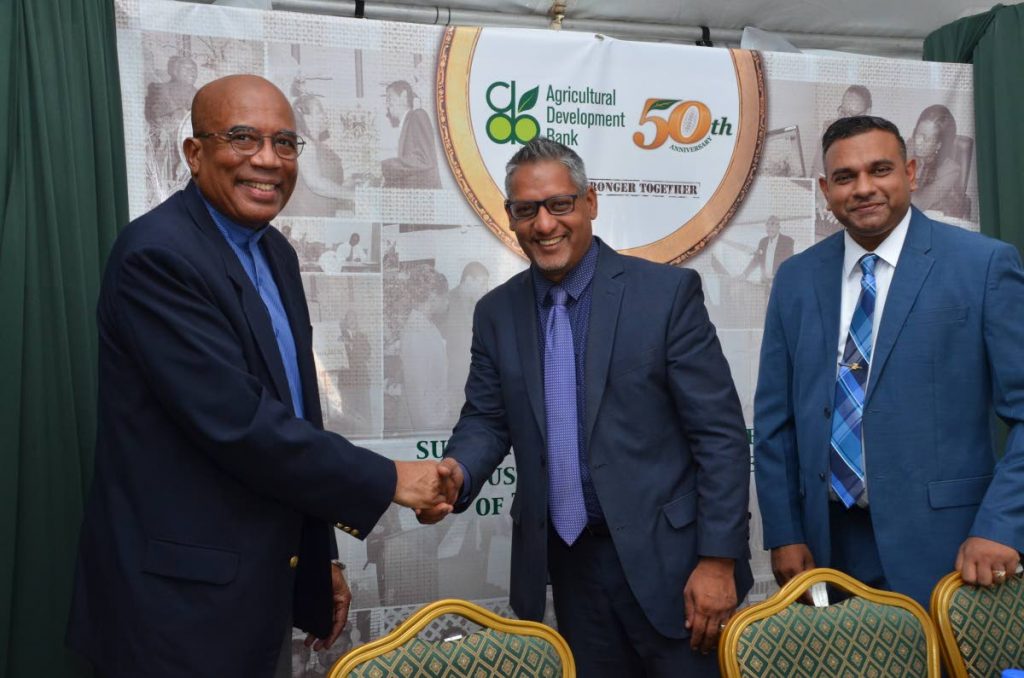 Cepep chairman Winston Rudder shakes hands with Agriculture Minister Clarence Rambharat