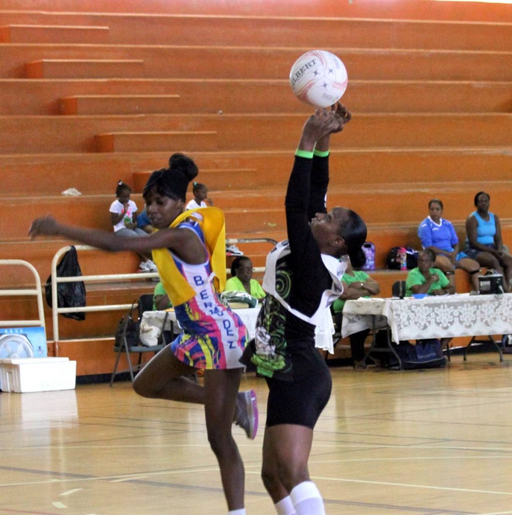 TSTT’s Melissa Stephenson, right, catches the ball against Bermudez in a Courts All Sectors Netball League championship division match last month
