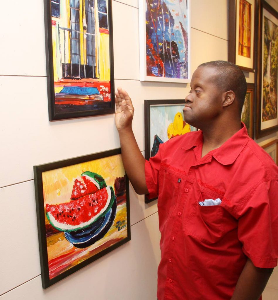 John Williams views his artwork, including his favourite one of a watermelon, at Horizon Art Gallery, Mucurapo. His second exhibition Dis-Is-Ability II runs from February 5 to 9. PHOTO BY ANGELO MARCELLE