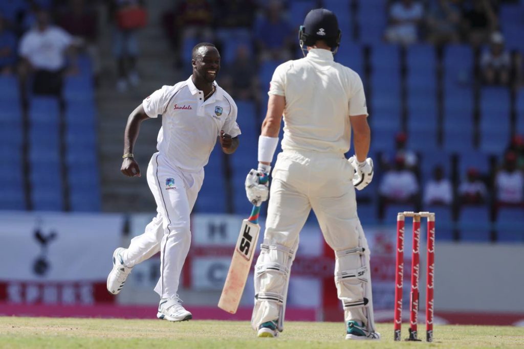 West Indies pacer Kemar Roach celebrates dismissing England's Rory Burns on day one of the 2nd Test at the Sir Vivian Richards Stadium in North Sound, Antigua, yesterday. (AP)