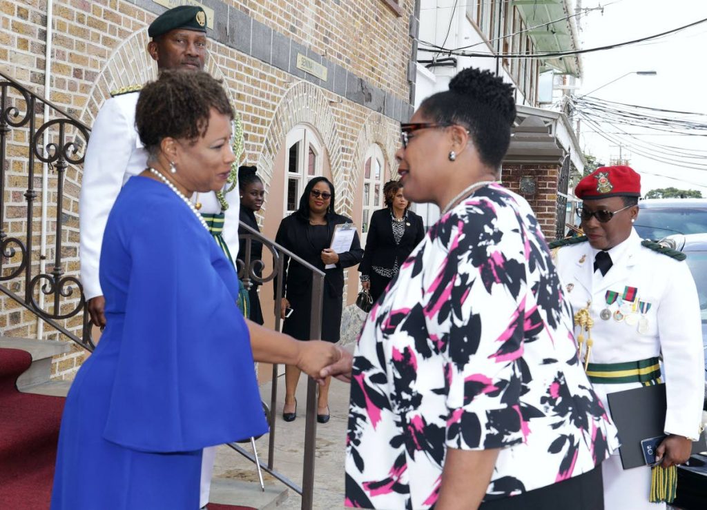 Tobago House of Assembly (THA) Presiding Officer Dr Denise Tsoiafatt-Angus, left, greets President Paula-Mae Weekes at the THA's legislative chamber on Thursday, 2019. PHOTO COURTESY THA INFO DEPT