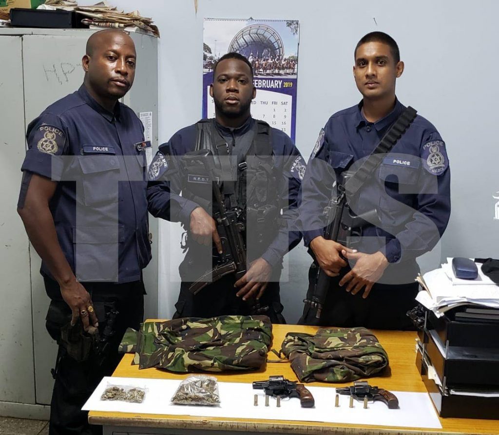 North Eastern Division officers with two guns, ammo and camouflage jackets seized during exercises overnight on Friday. PHOTO COURTESY TTPS