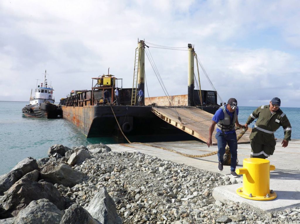 Barge operators at work at the Barbados Bay jetty at Studley Park Tobago on January 26.